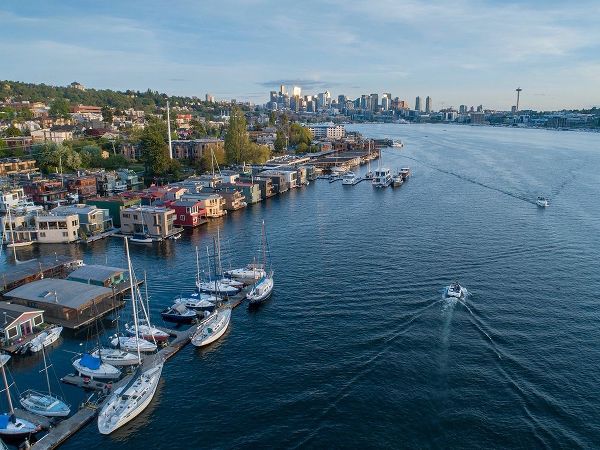 Aerial view of sailboats and houseboats on Lake Union with downtown Seattle in the background